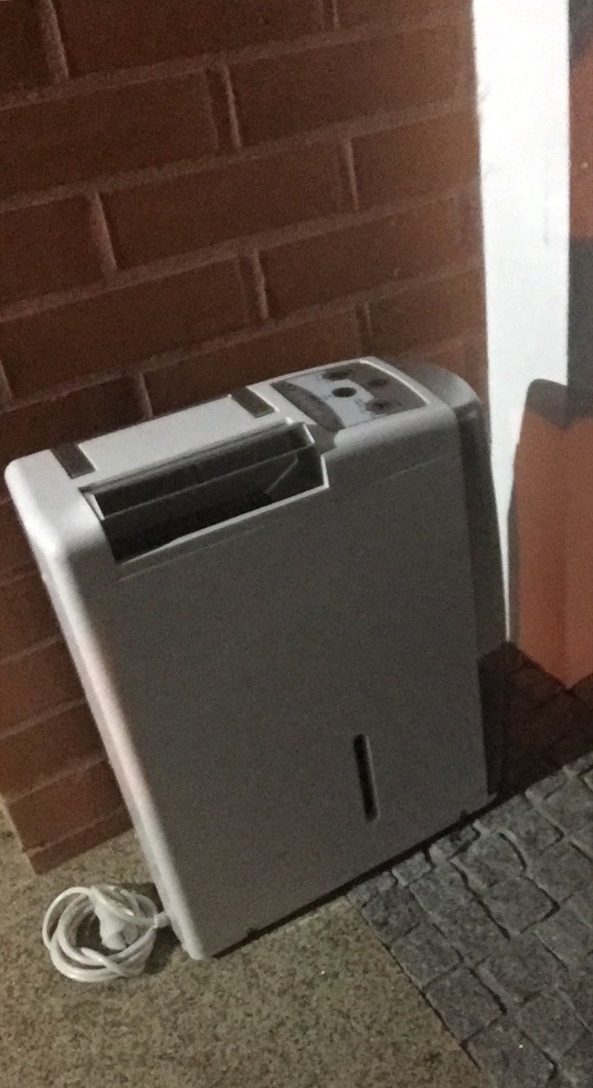 A dehumidifier positioned to dry a damp interior space