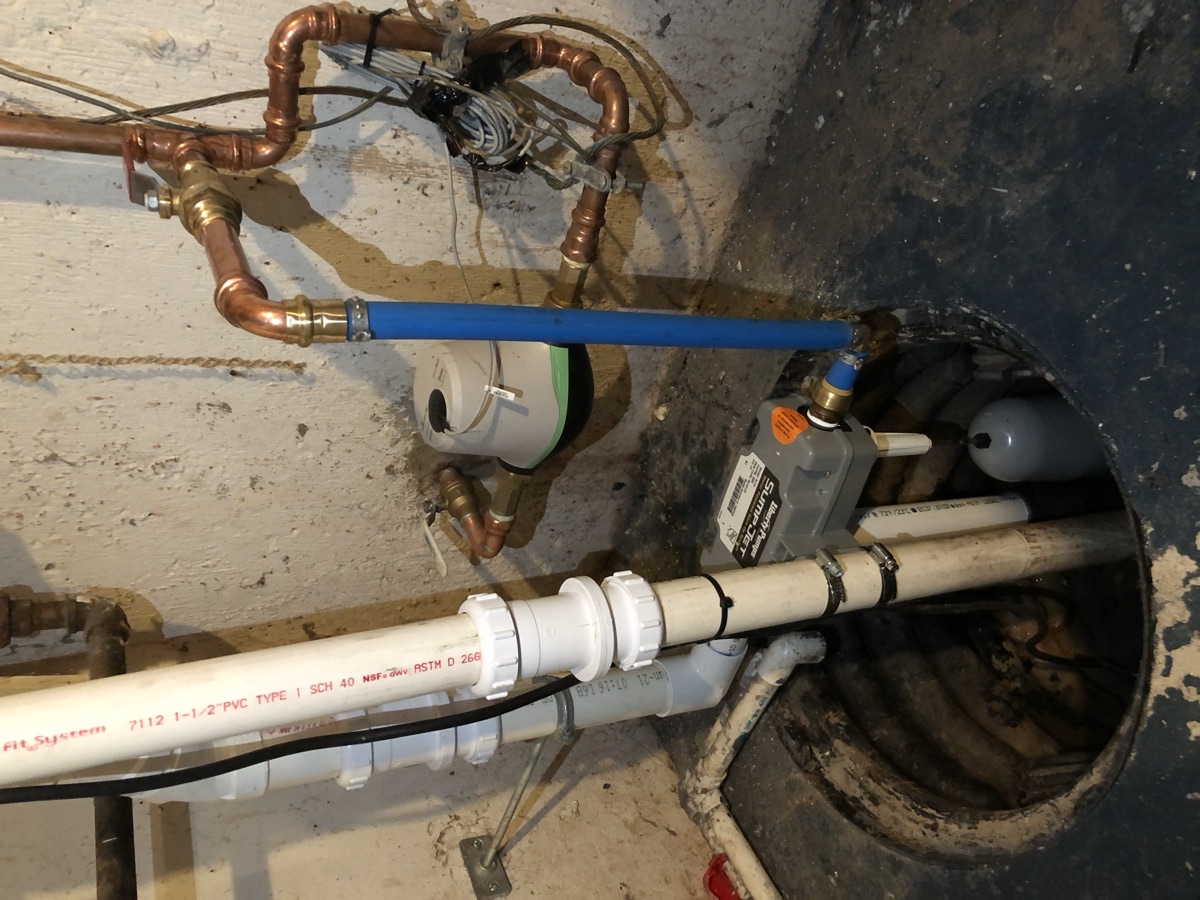 A sump pump installed in a residential basement to manage groundwater