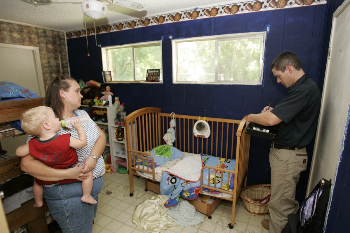 FEMA damage inspector documenting flood damage inside a resident's home