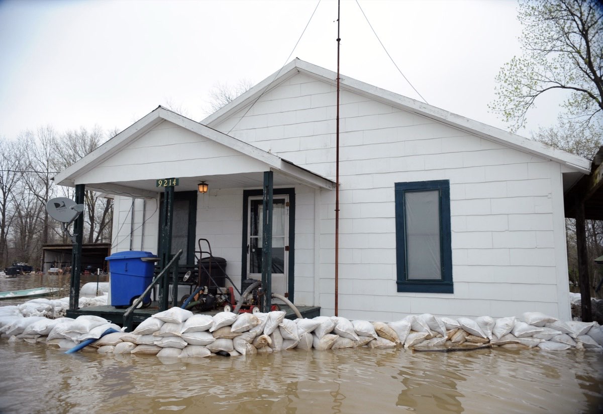 Sandbags stacked around a home to hold back rising floodwater