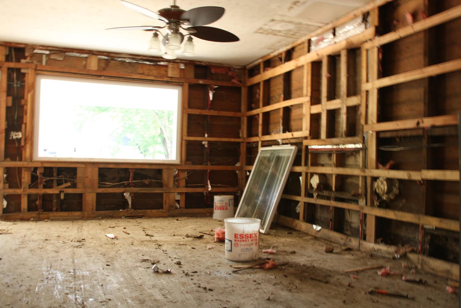 Flood-damaged home interior being dried out and cleaned after water damage