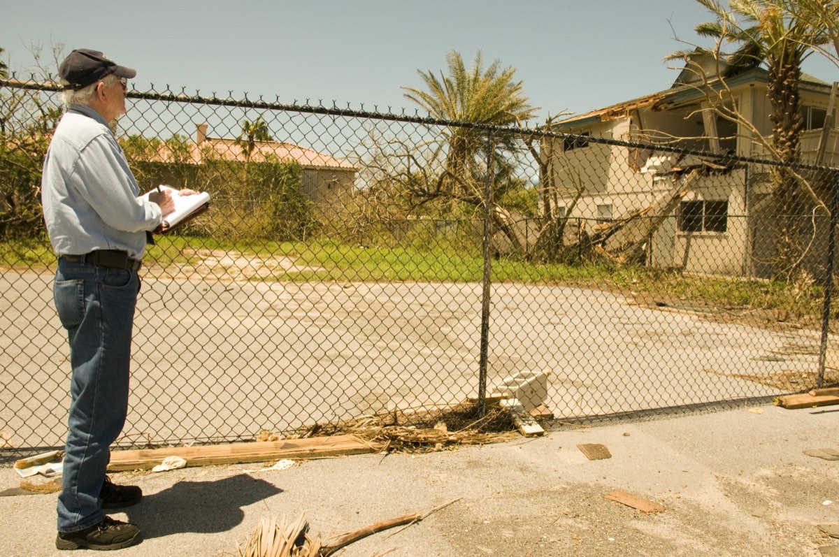 A damage inspector examines a flood-affected home before residents move back in