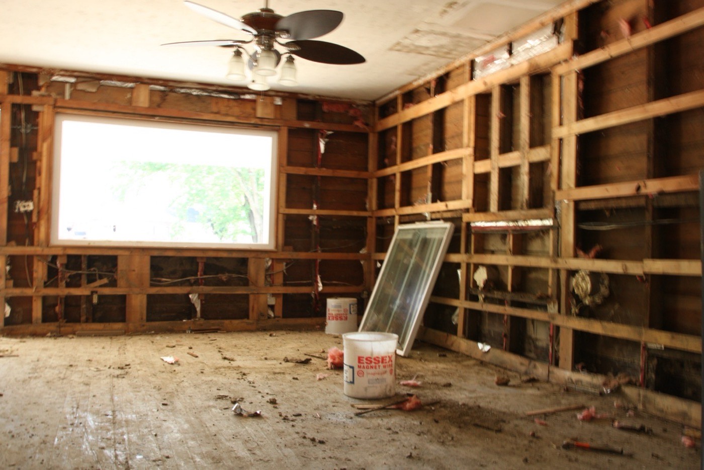 Interior of a home with insulation stripped from the walls after a water loss, the kind of damage that must be classified as either a water damage or a flood insurance claim