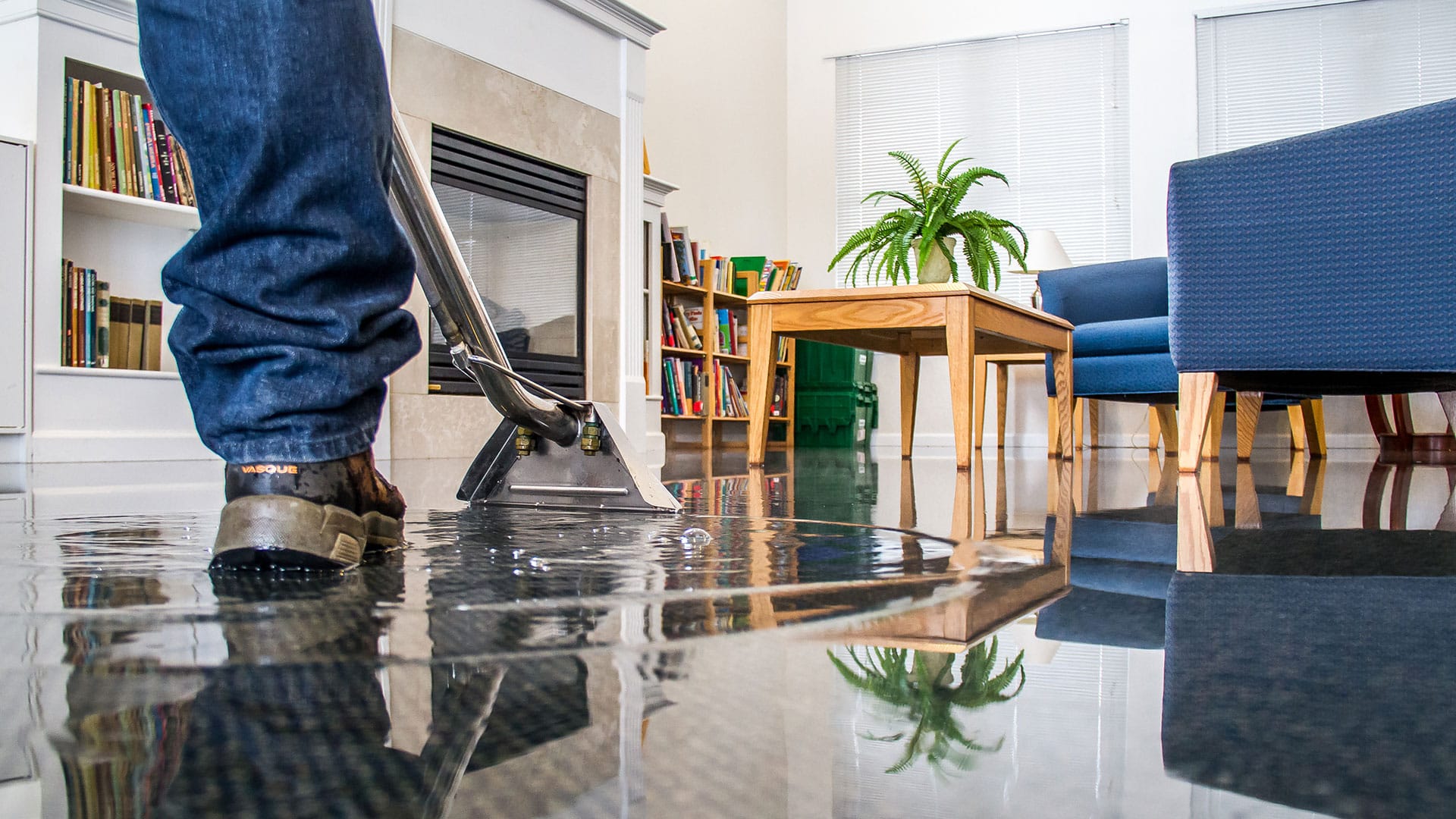 Professional water extraction and flood repair service in a flooded living room