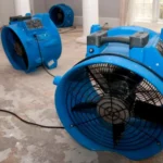 Multiple air movers drying out a water-damaged home after a flood