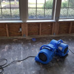 Industrial drying equipment set up in a flood-damaged home to expedite the drying process